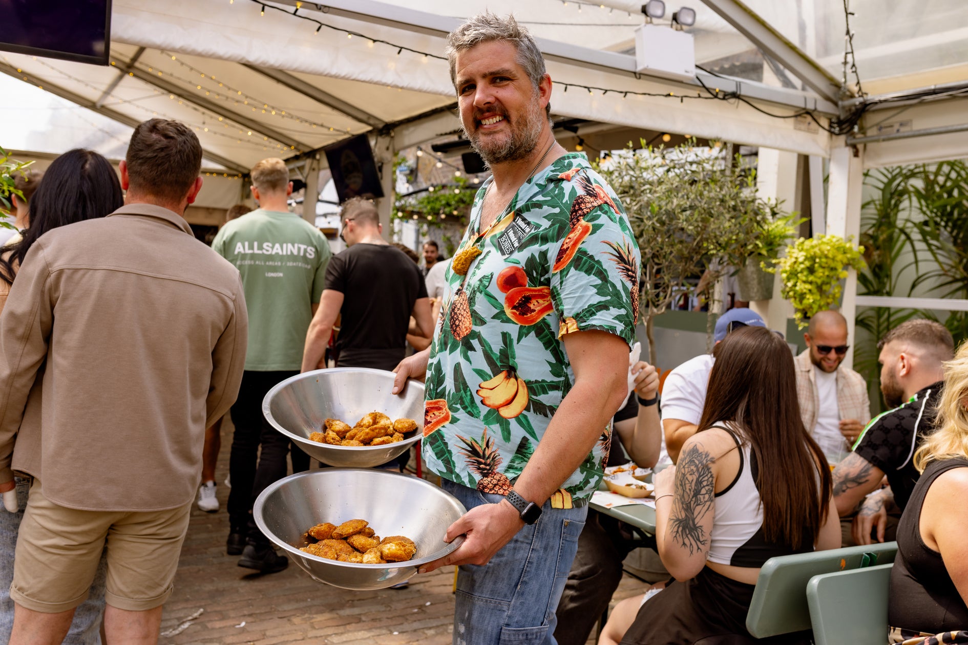 Gary from bones shows their amazing plain wings , WingJam London A Gathering of Friends for Great Food, WingJam London Where Friends Feast on the Best Wings, WingJam London A Festival for Foodies and Friends, WingJam London Best Place to Enjoy Chicken Wings and Fun, WingJam London Friends Savoring the Festival’s Best Wings, WingJam London A Celebration of Flavor and Friends, WingJam London People Enjoying the Ultimate Wing Feast