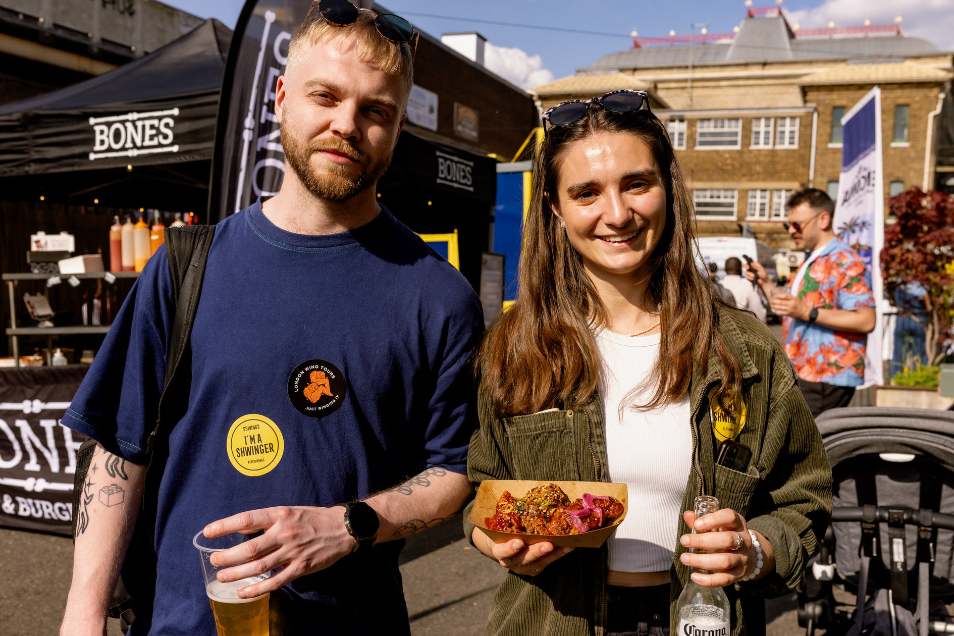 a couple enjoying their time at wingjam festival , wingJam London Friends Loving the Delicious Chicken Wings, WingJam London Where Friends Come Together for Food and Fun, WingJam London A Celebration of Chicken Wings and Friendship, WingJam London People Feasting on the Best Chicken Wings