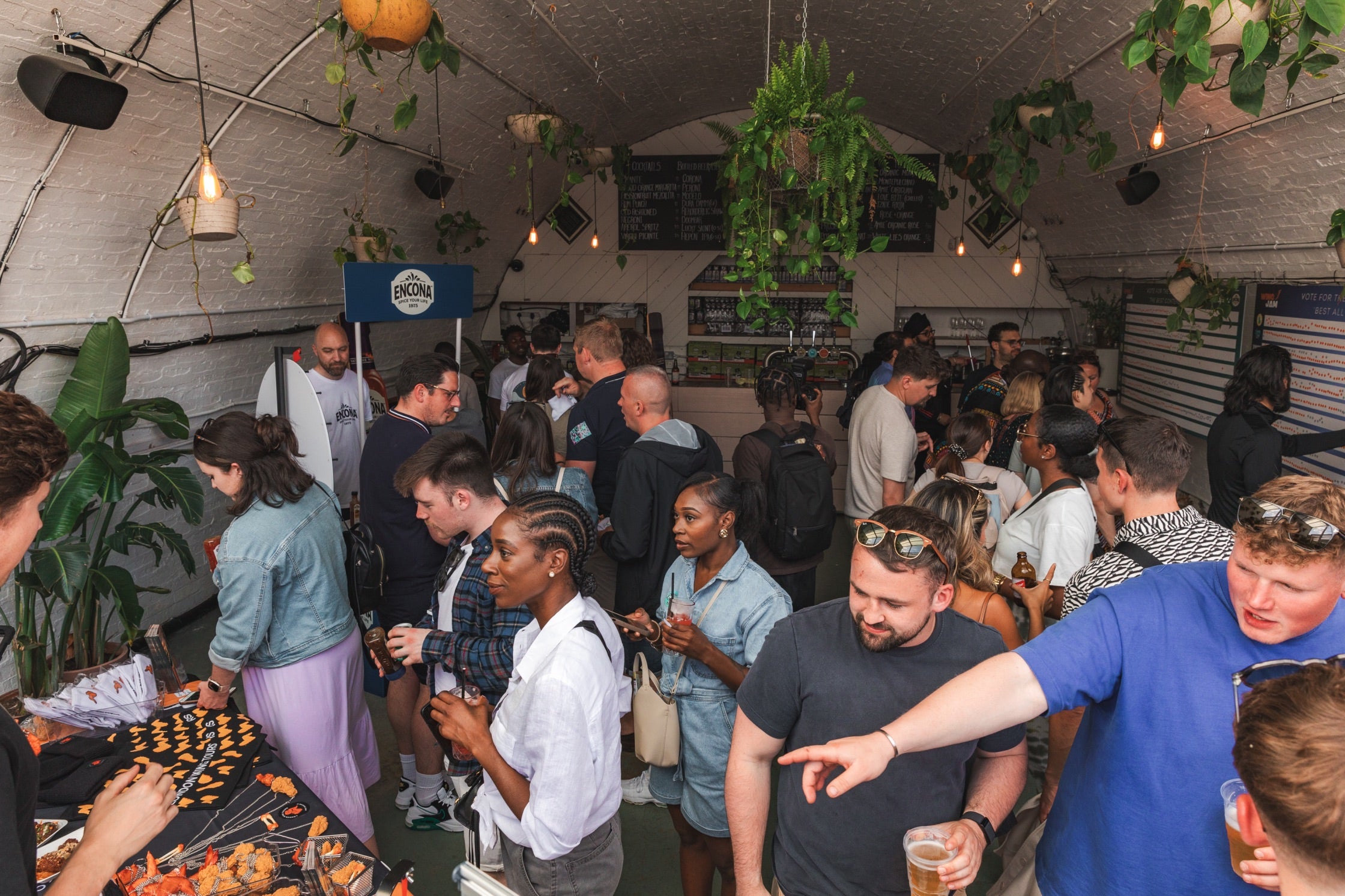 a crowd gathering at Peckham Arches for a wingjam London's best chicken wing event, WingJam Festival London Top Chicken Wings and Entertainment, Attendees Loving the WingJam Experience in London, WingJam 2024 London’s Premier Chicken Wing Event