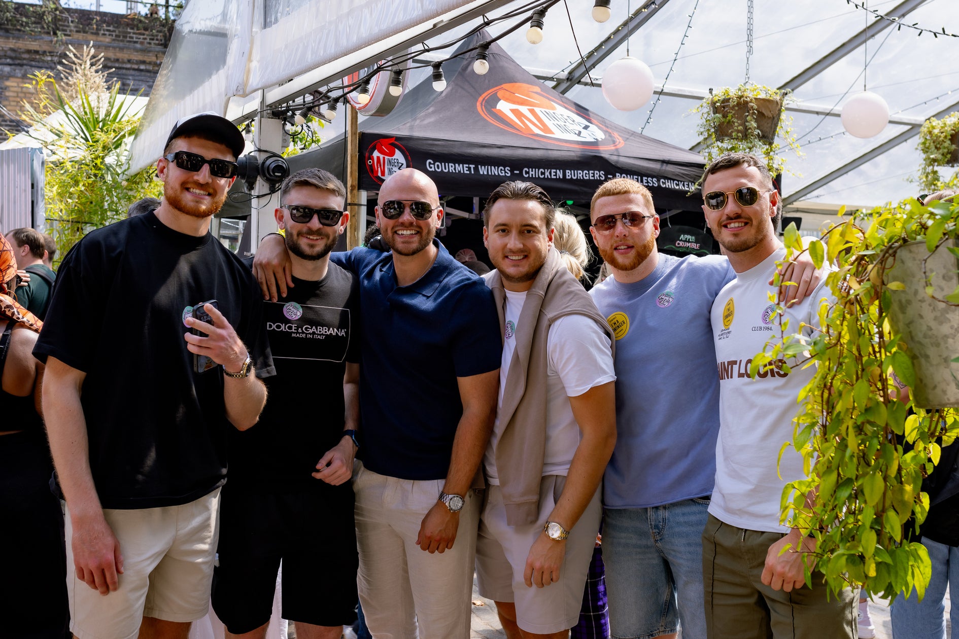 a group of friends enjoying their time at wingjam chicken wing festival, WingJam London A Fun and Tasty Day Out, WingJam London Where Friends Enjoy Every Bite, WingJam London The Best Chicken Wing Festival in Town, WingJam London A Celebration of Flavor and Fun