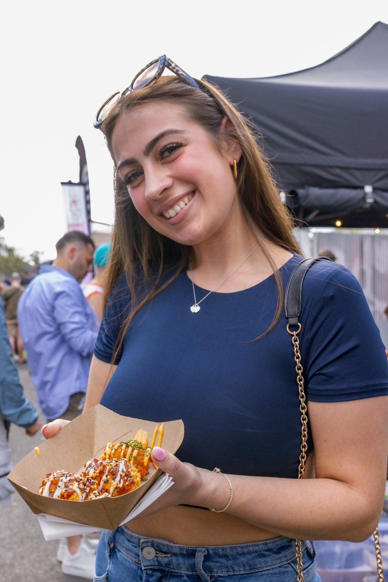 a lovely girl enjoying mouthwatering wings from jus winging it at wingjam, WingJam London A Fun and Tasty Event for All, WingJam London Where Friends Feast on the Best Wings, WingJam London A Festival for Wing Lovers and Foodies, WingJam London The Ultimate Gathering for Chicken Wing Fans
