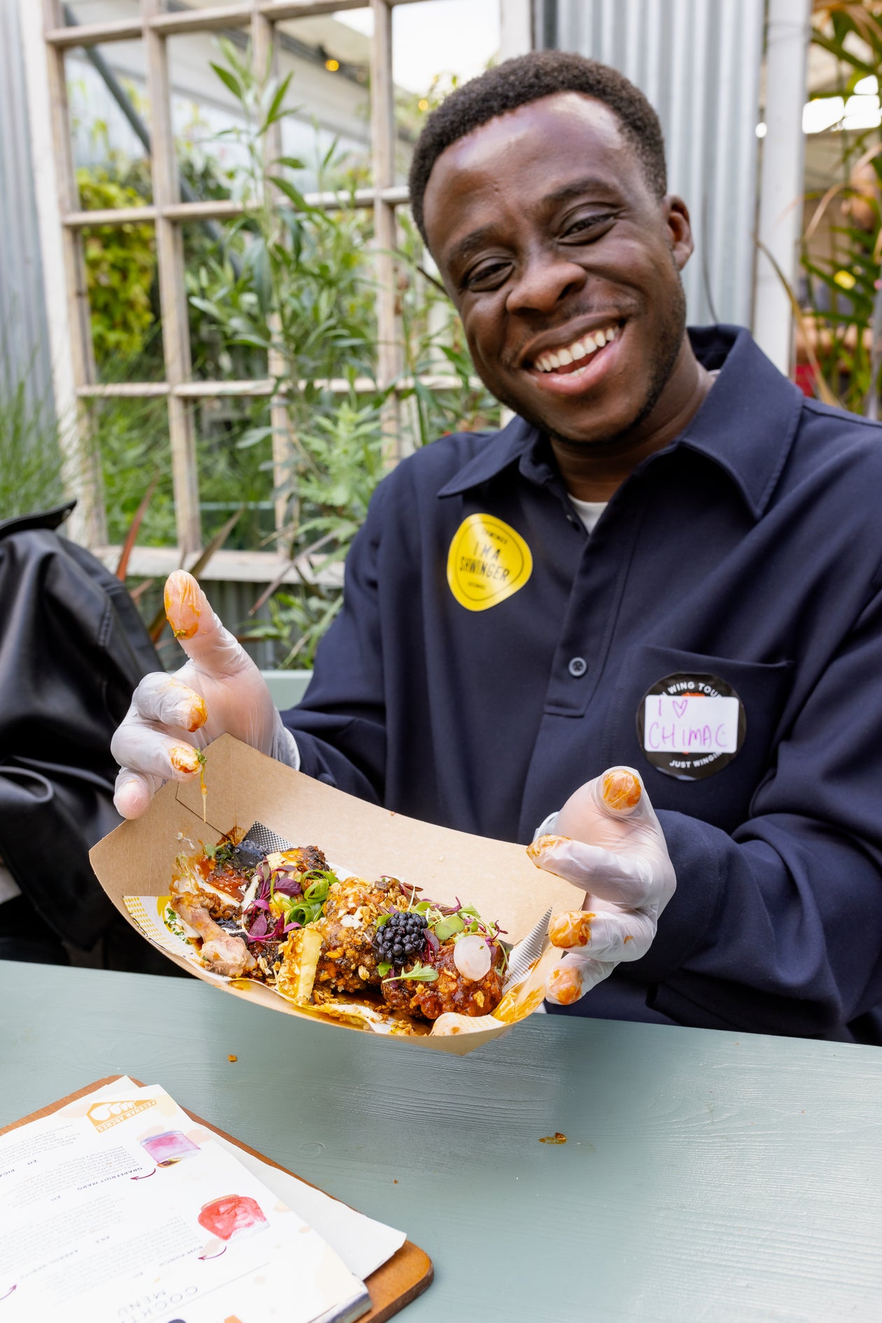 visitors enjoying amazing wings from Shwings at wingjam 2024, WingJam London Friends Loving Every Flavorful Wing, WingJam London A Celebration of Friends and Flavor, WingJam London The Ultimate Gathering for Wing Lovers, WingJam London A Fun and Tasty Festival Experience, WingJam London Where Friends Feast on the Best Chicken Wings