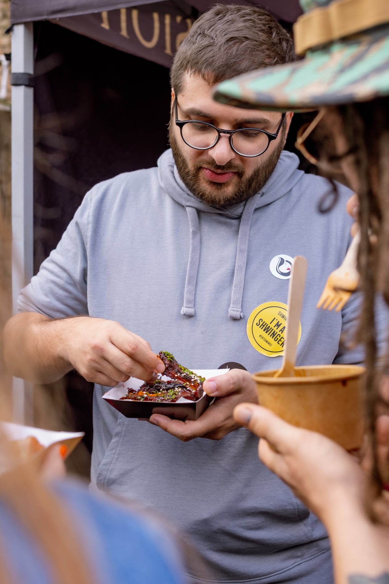 visitors tasting korean cowgirl's creations at wingjam , WingJam London The Best Event for Chicken Wing Enthusiasts, WingJam London Friends Enjoying the Ultimate Food Experience, WingJam London A Celebration of Good Food and Good Friends, WingJam London Where People Savor the Best Chicken Wings, WingJam London A Fun and Flavorful Food Festival