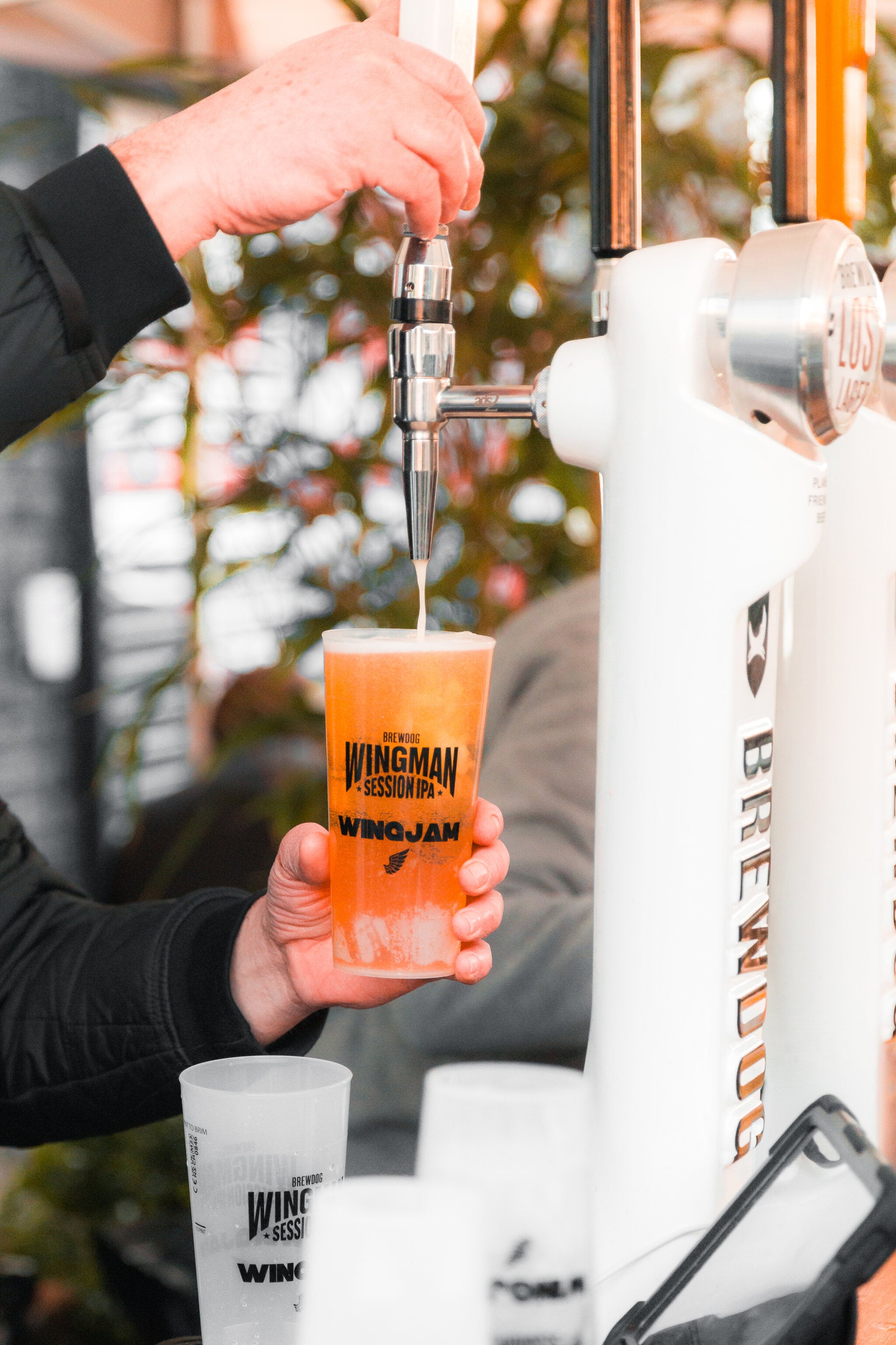 wingman brewdog's beer at wingjam, WingJam London Food and Fun for All, London WingJam Festival Friends Enjoying Every Moment, WingJam London Where Chicken Wings Are King, WingJam London A Fun-Filled Food Festival, London WingJam Festival Crowds Enjoying Every Bite, WingJam London Where Friends and Foodies Unite