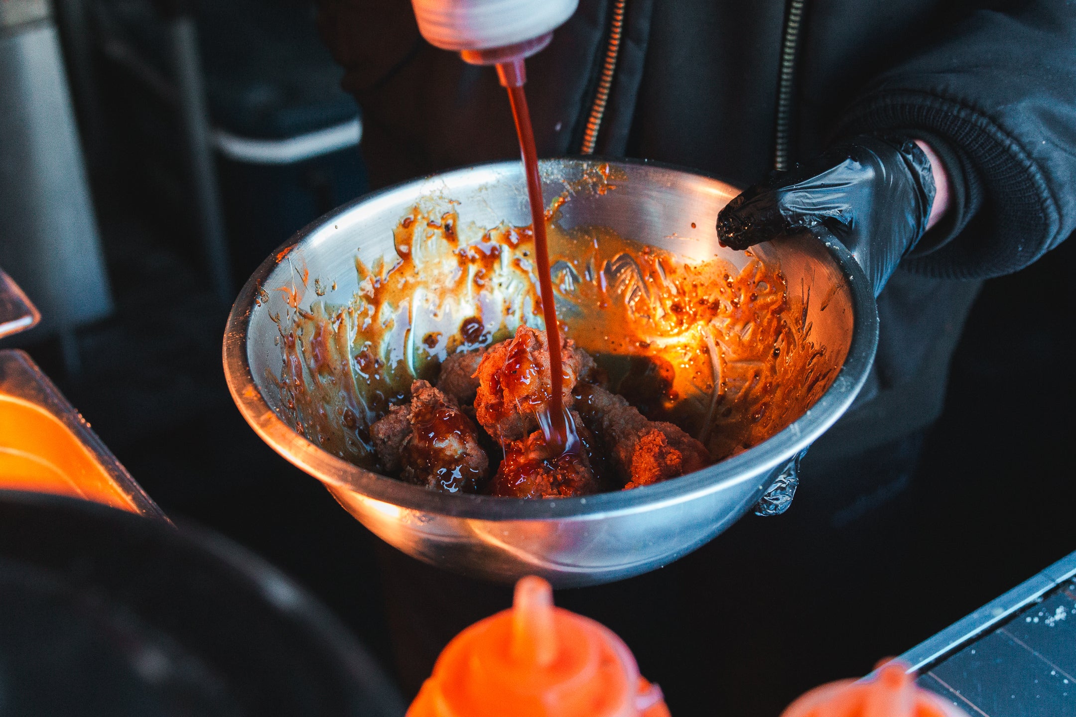 wings dipped in the mouthwatering sauce at wingjam, WingJam London People Relishing the Best Chicken Wing Experience, WingJam London A Flavorful Gathering of Food Lovers, WingJam London Friends Enjoying Every Delicious Wing Bite, WingJam London A Celebration of Chicken Wings and Good Company